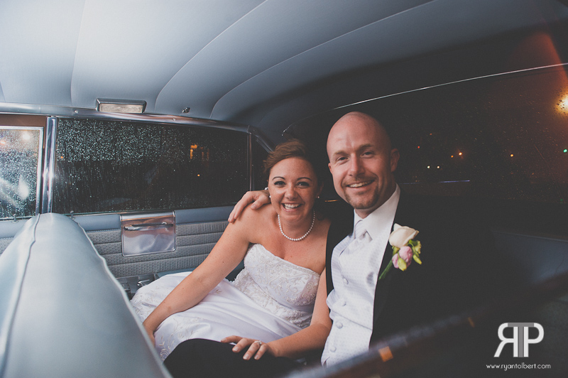 Wedding couple inside of getaway vehicle