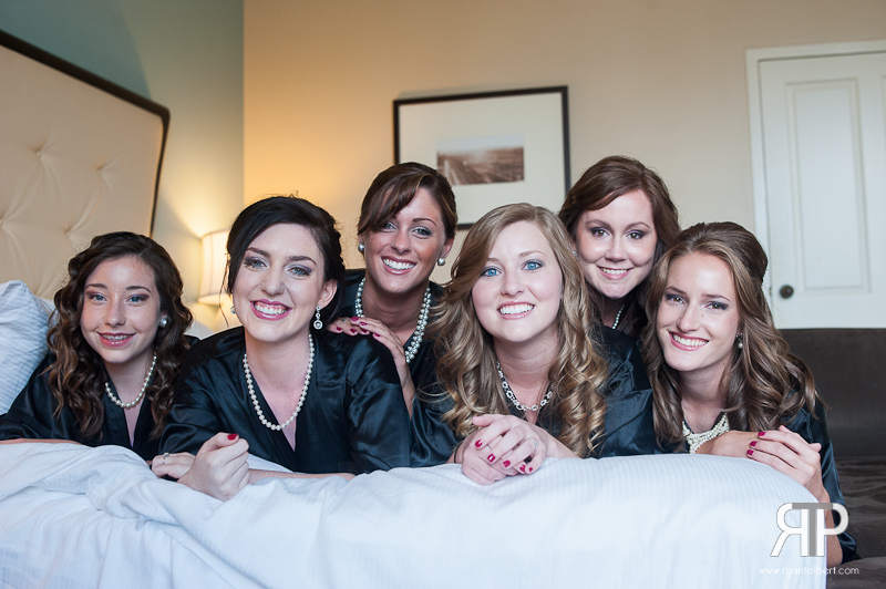 bride and bridesmaids on the bed